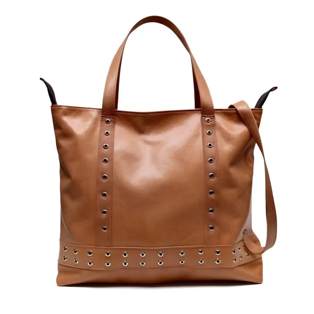 Tan leather shopper bag with studded rivet detail, dual handles and crossbody strap on white background