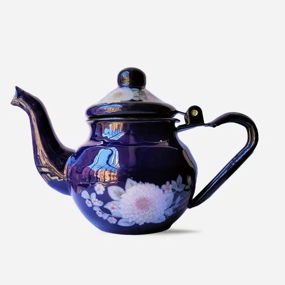 Hand-painted enamel floral teapot in deep cobalt blue with white and pink chrysanthemum blossoms, bulbous body with domed lid and brass hinge