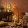 Brass filigree table lamps in bohemian living space creating warm ambient glow with decorative shadows Brass filigree table lamps in bohemian living space creating warm ambient glow with decorative shadows