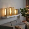 Set of brass lantern table lamps on floating shelf casting decorative shadow patterns in modern living room Set of brass lantern table lamps on floating shelf casting decorative shadow patterns in modern living room