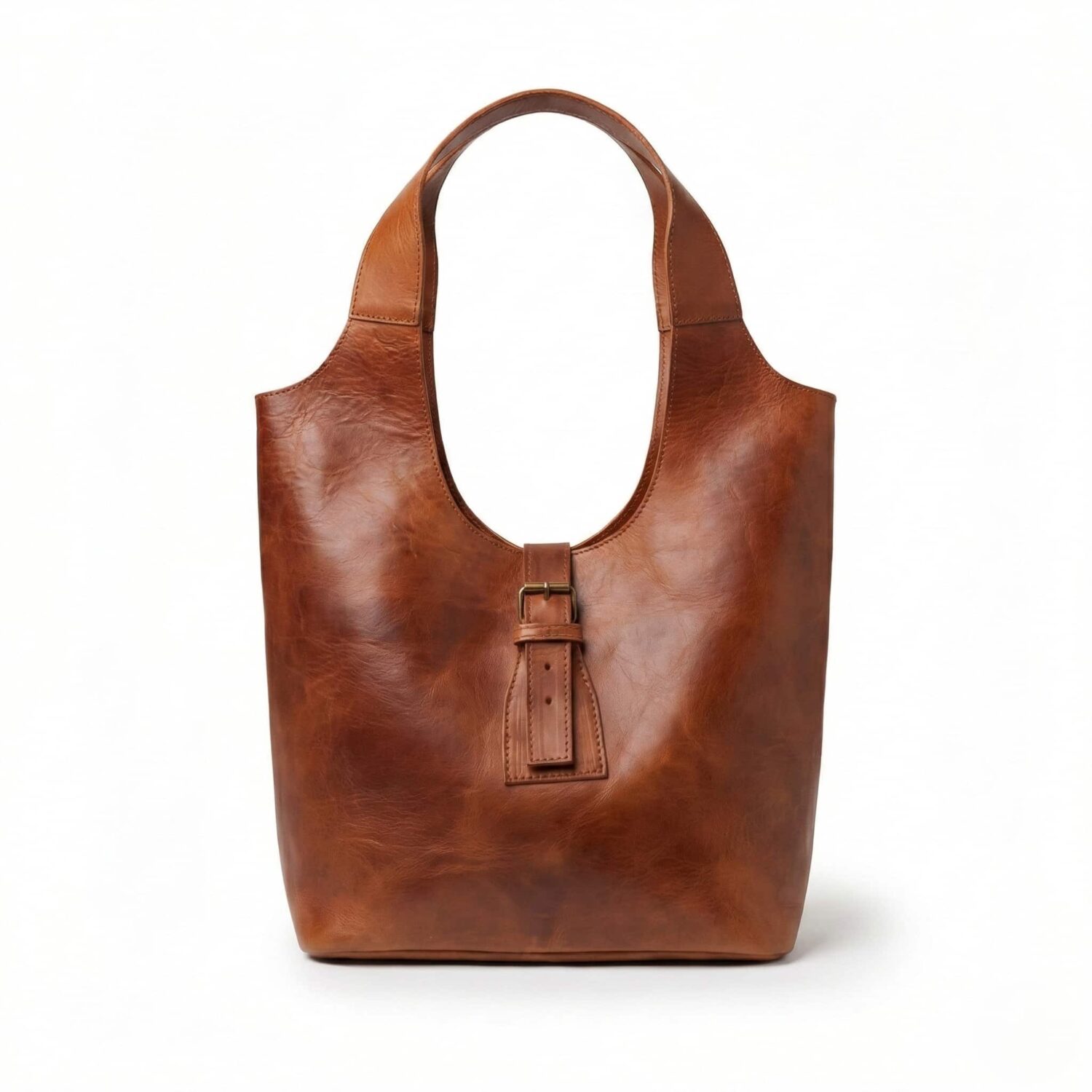 Handcrafted brown leather hobo shoulder bag featuring a slouchy silhouette, single top handle, and solid brass buckle detail on white background.