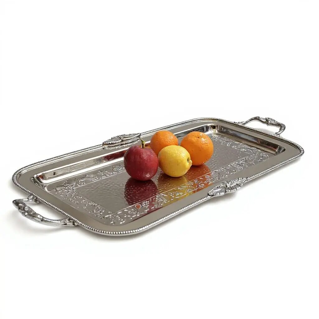 Rectangular silver tray with hammered center, hand-engraved floral border, and scrolled handles on white background Rectangular silver tray with hammered center, hand-engraved floral border, and scrolled handles on white background