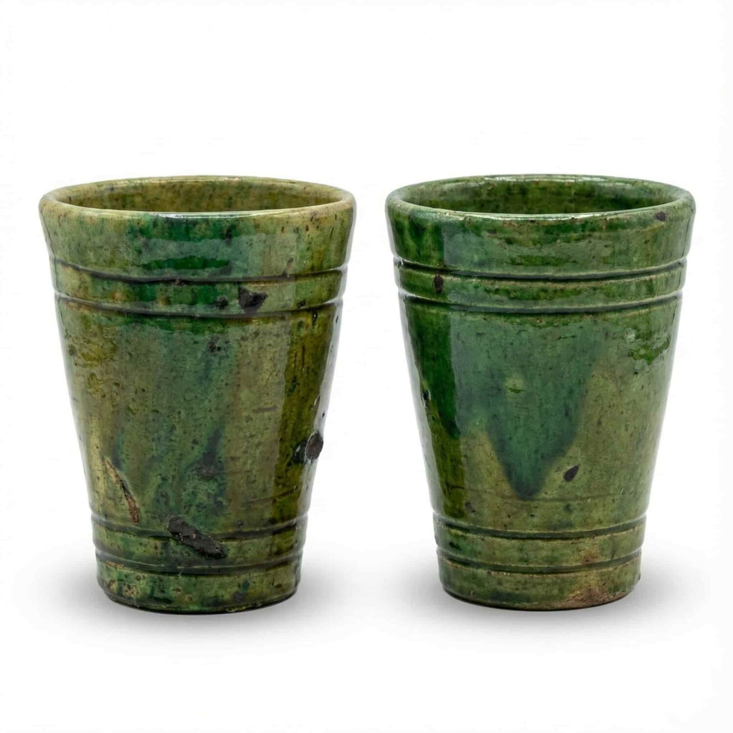 Set of two handcrafted ceramic mugs showing natural glaze variations Set of two handcrafted ceramic mugs showing natural glaze variations