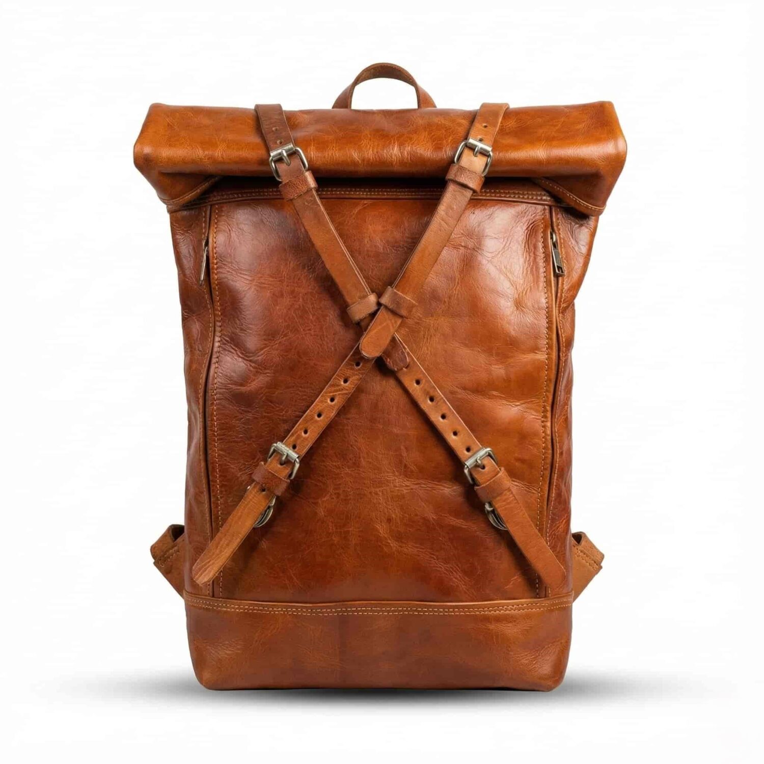 Tan leather roll top backpack with X-strap buckle detail and side zippers on white studio background Tan leather roll top backpack with X-strap buckle detail and side zippers on white studio background