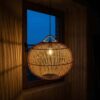 Rattan pendant light shade glowing warm at night – handwoven wicker ceiling lamp Rattan pendant light shade glowing warm at night – handwoven wicker ceiling lamp