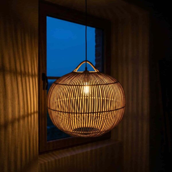 Rattan pendant light shade glowing warm at night – handwoven wicker ceiling lamp Rattan pendant light shade glowing warm at night – handwoven wicker ceiling lamp