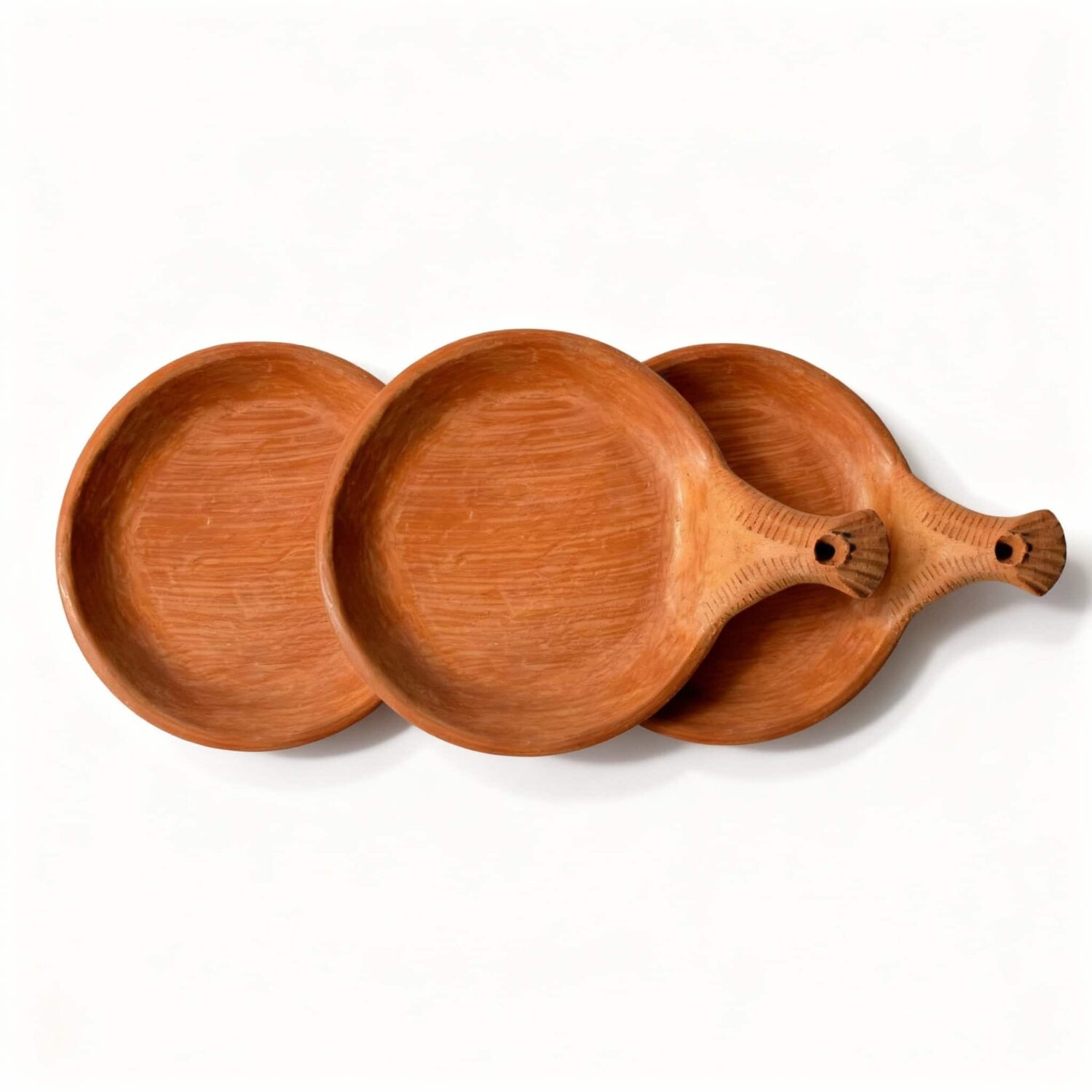 Set of three terracotta serving dishes with handles arranged together showing matching handmade design Set of three terracotta serving dishes with handles arranged together showing matching handmade design