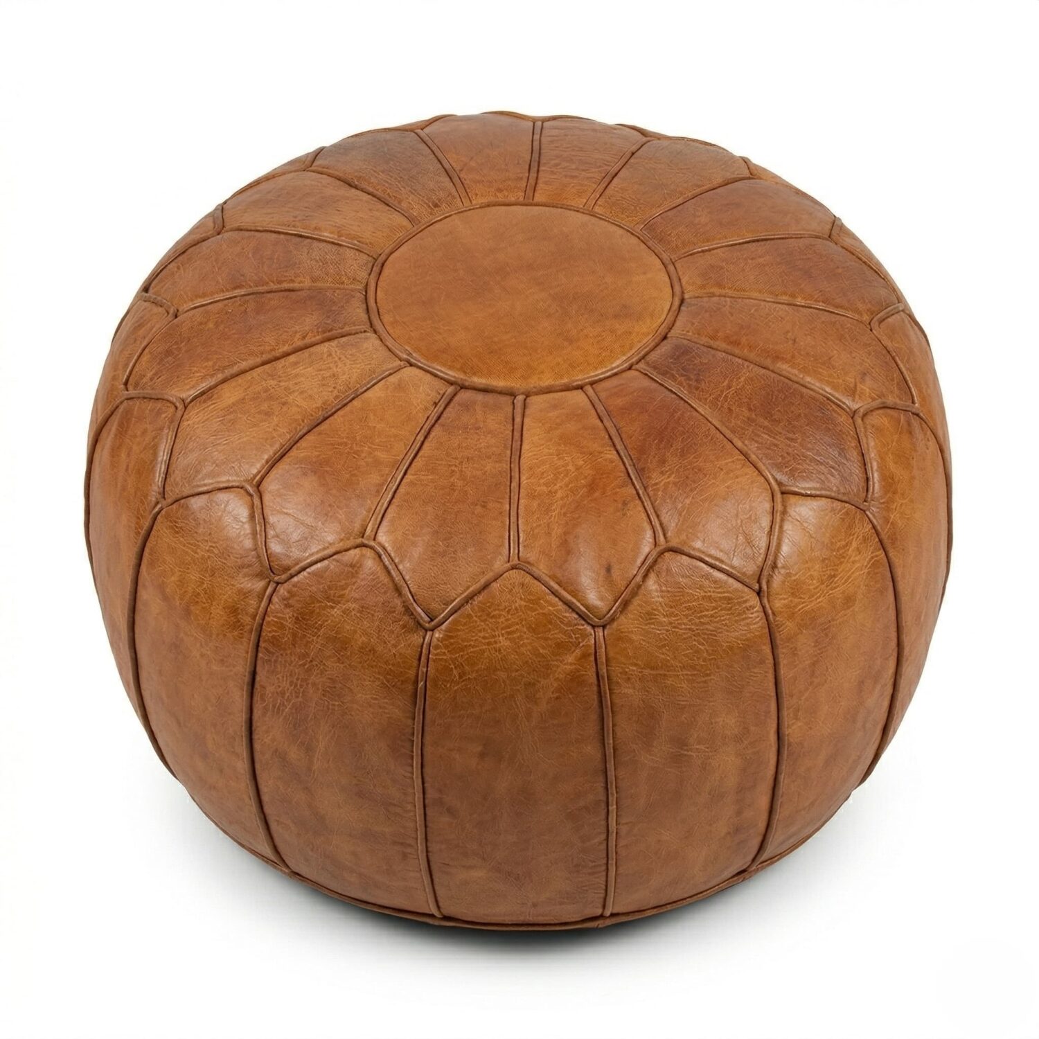 Light brown genuine leather round pouf with geometric patchwork panels on white background.