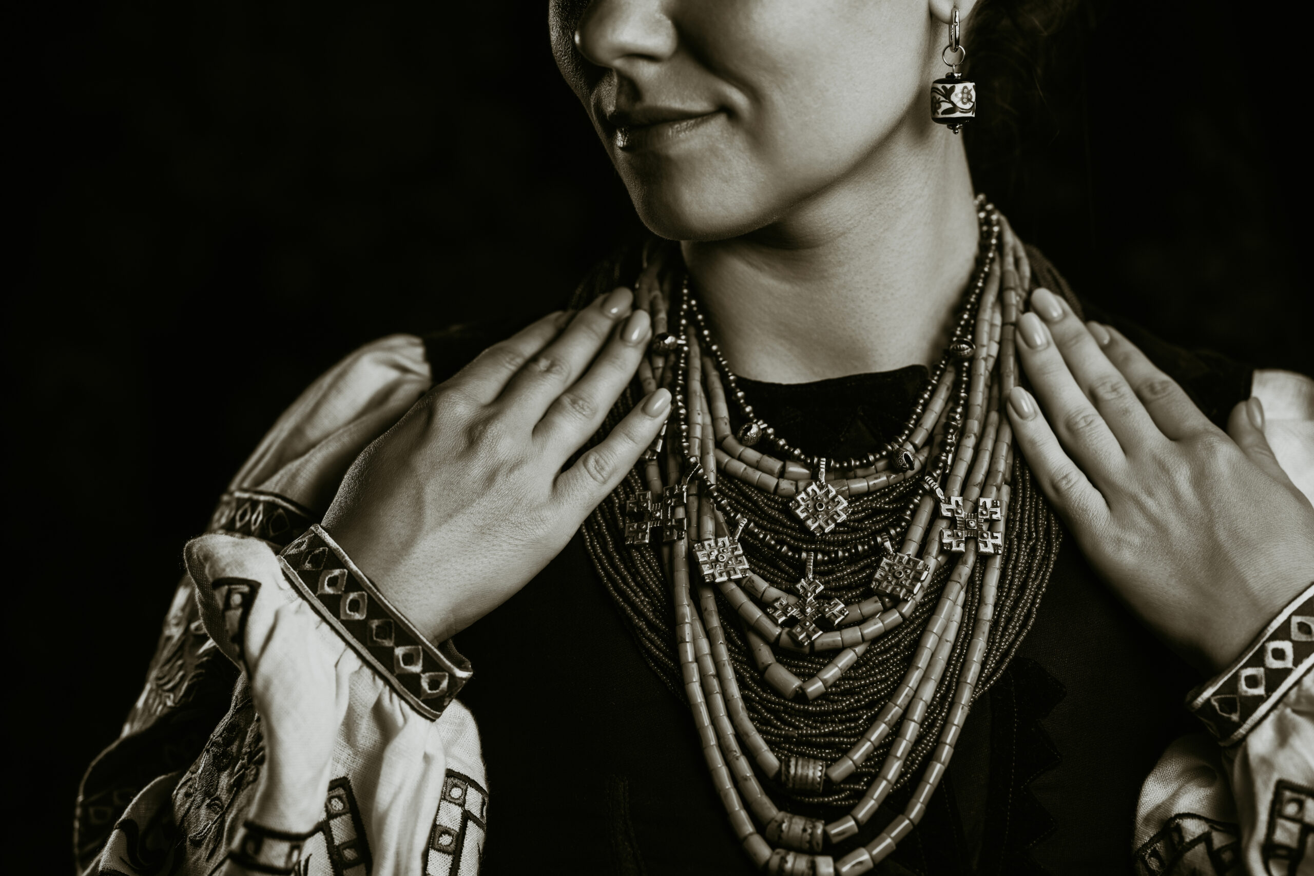 Demonstrating traditional antique jewelry necklace. National costume of Ukraine. Ukrainian woman in legacy ancient coral beads, Zgarda - archaic hutsul neck ornament of status religious purpose.
