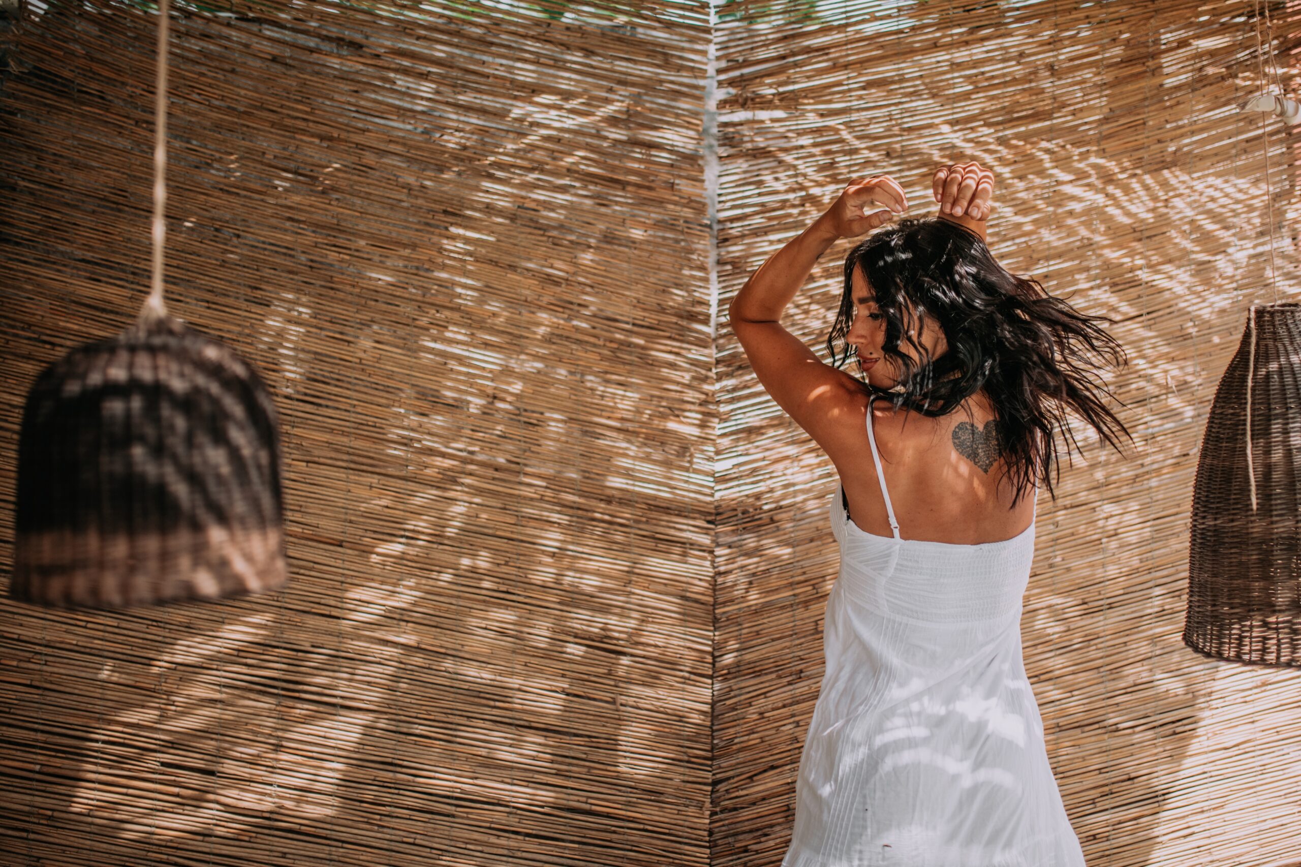 woman-in-white-dress-posing-near-bamboo-wall-2026-03-11-00-56-30-utc