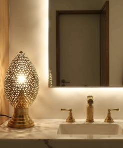 Moroccan brass egg lamp casting patterned light on a bathroom vanity next to brass taps