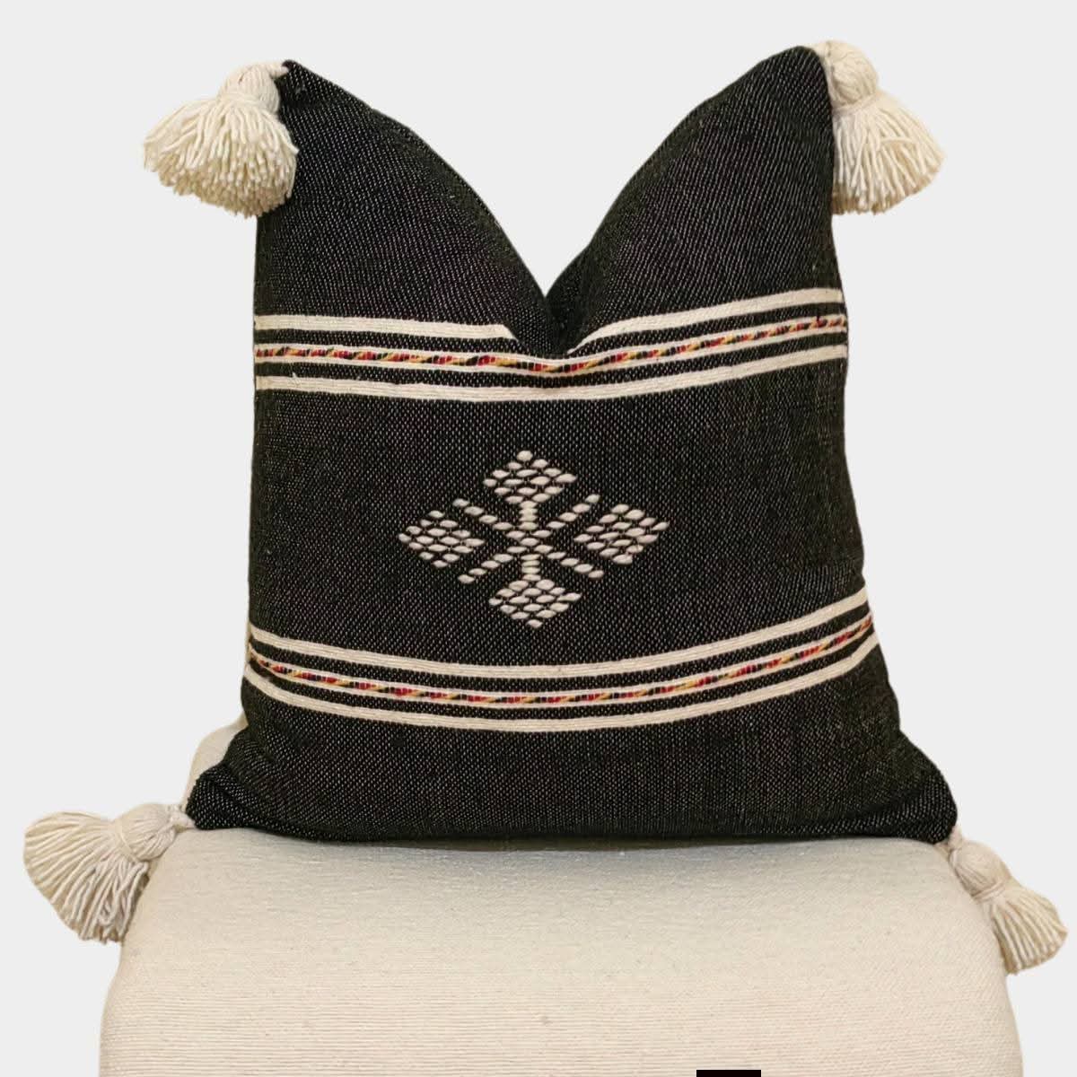 Black Moroccan kilim pillow cover with large ivory corner tassels and Berber motif