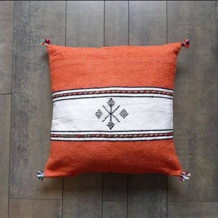 Handwoven Moroccan kilim pillow cover in orange with a white central band and Berber motif