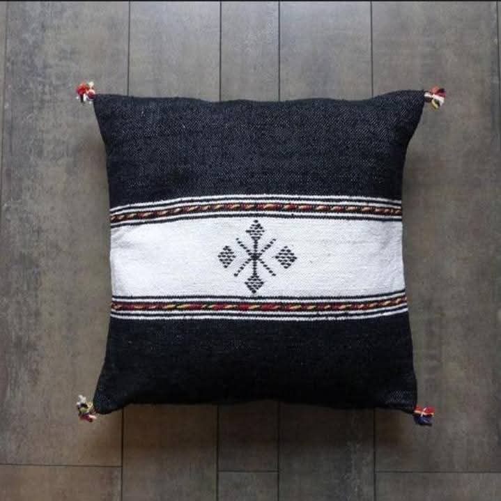 Handwoven Moroccan kilim pillow cover in black with a white central band and Berber motif