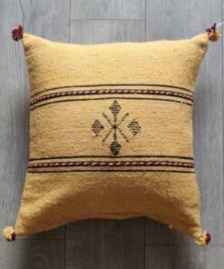 Handwoven Moroccan kilim pillow cover in mustard yellow with Berber motif and pompom corners