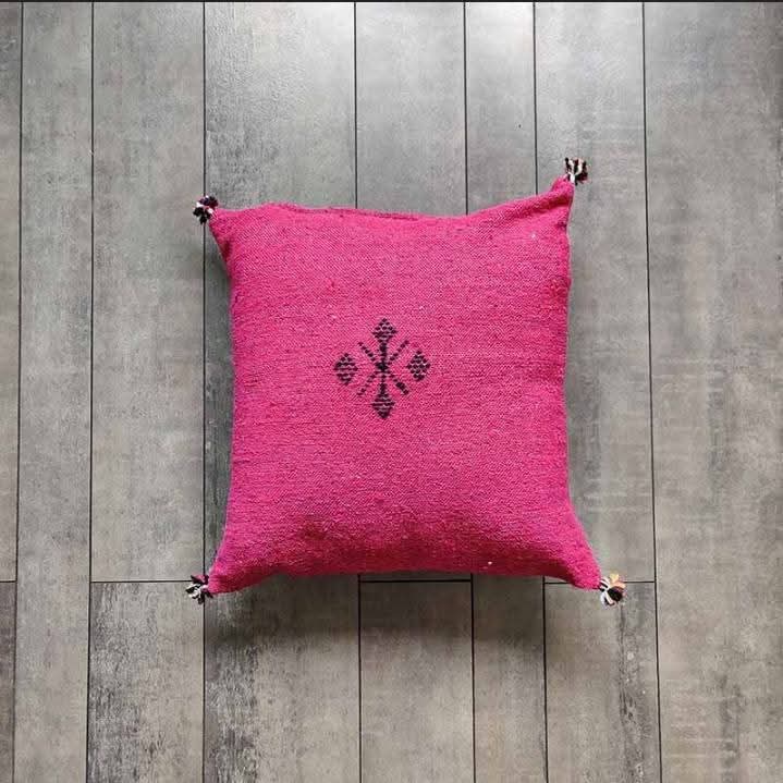 Handwoven Moroccan kilim pillow cover in fuchsia with Berber motif and pompom corners