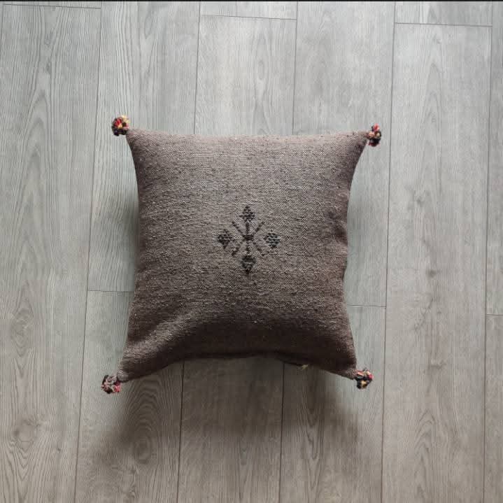 Handwoven Moroccan kilim pillow cover in taupe brown with Berber motif and pompom corners