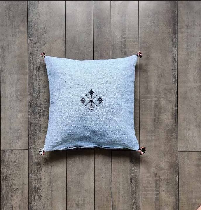 Sky blue Moroccan kilim pillow cover with a single woven Berber motif