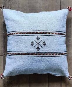 Handwoven Moroccan kilim pillow cover in sky blue with Berber motif and pompom corners