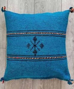 Handwoven Moroccan kilim pillow cover in petrol blue with Berber motif and pompom corners