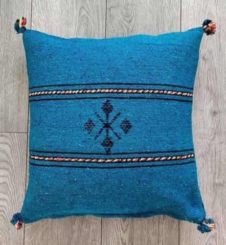 Handwoven Moroccan kilim pillow cover in petrol blue with Berber motif and pompom corners
