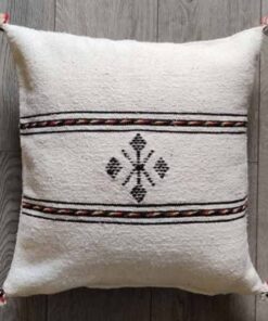 Handwoven Moroccan kilim pillow cover in ivory with Berber motif and pompom corners