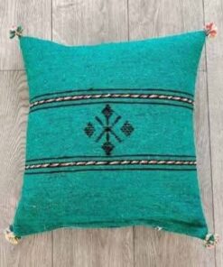 Handwoven Moroccan kilim pillow cover in emerald green with Berber motif and pompom corners