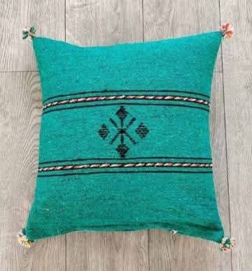 Handwoven Moroccan kilim pillow cover in emerald green with Berber motif and pompom corners