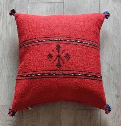 Handwoven Moroccan kilim pillow cover in red with Berber motif and pompom corners