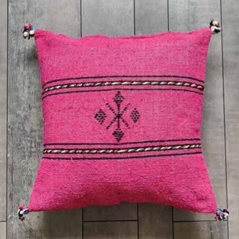 Handwoven Moroccan kilim pillow cover in pink with Berber motif and pompom corners