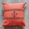 Handwoven Moroccan kilim pillow cover in coral with Berber motif and pompom corners