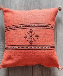 Handwoven Moroccan kilim pillow cover in coral with Berber motif and pompom corners