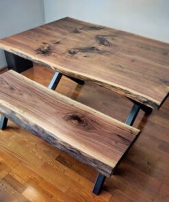 Live-edge walnut table top close-up with black base