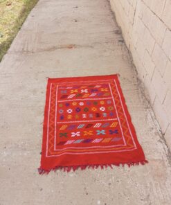 Warm red handwoven Moroccan kilim rug with white and gold zigzag borders