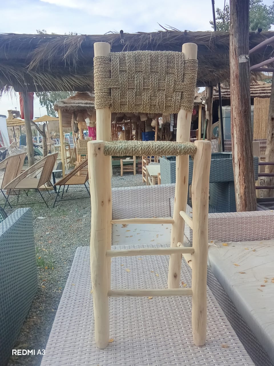 Natural eucalyptus bar stool with hand-woven cord back