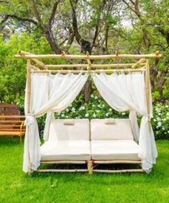 Eucalyptus canopy daybed with white voile curtains on a lawn
