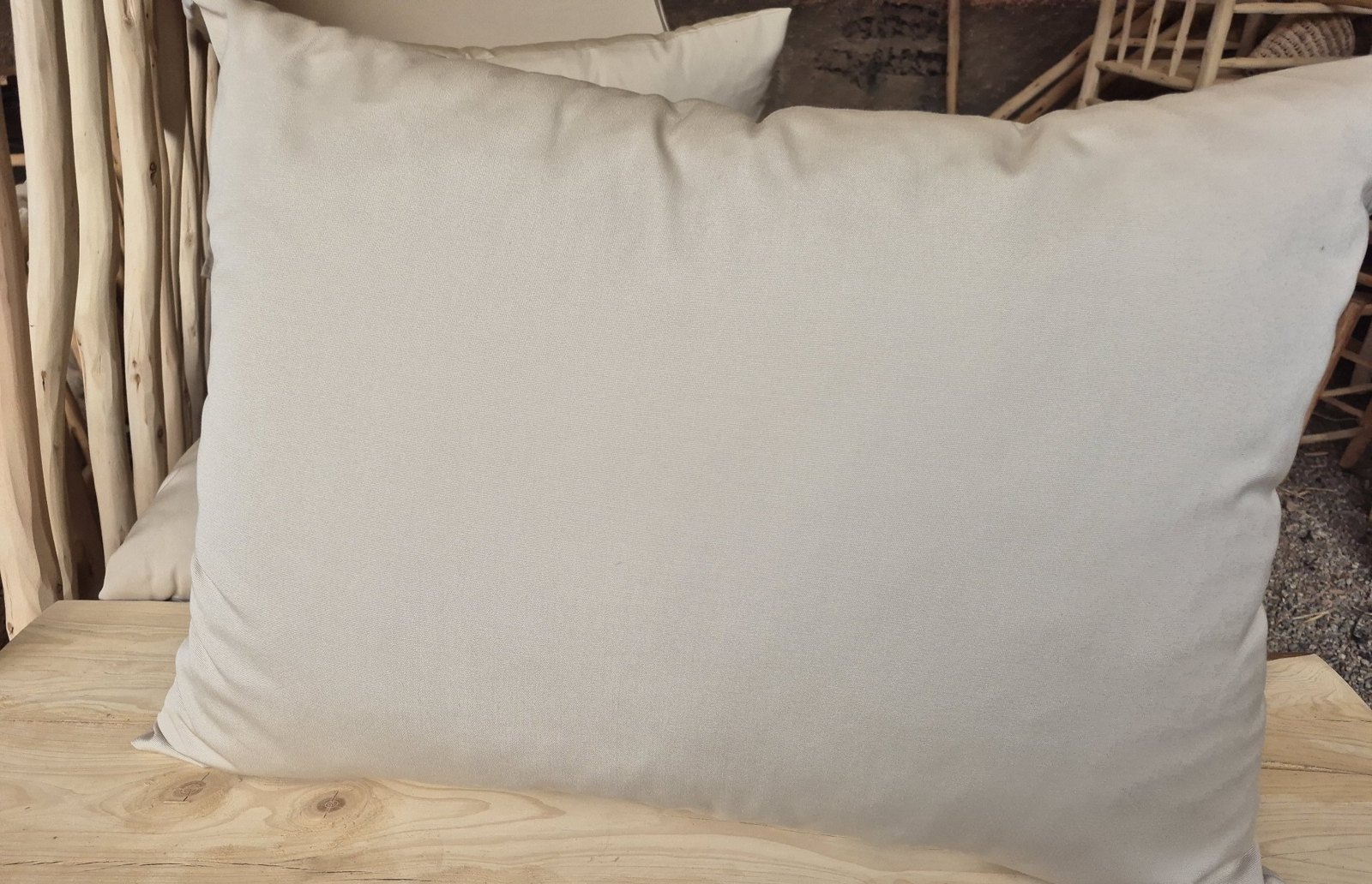 Beige outdoor cushion on a rattan chair seat pad