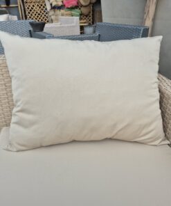 Large beige outdoor cushion on a wooden bench in the Marrakech workshop
