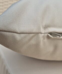 Close-up of the concealed zip on a beige outdoor canvas cushion