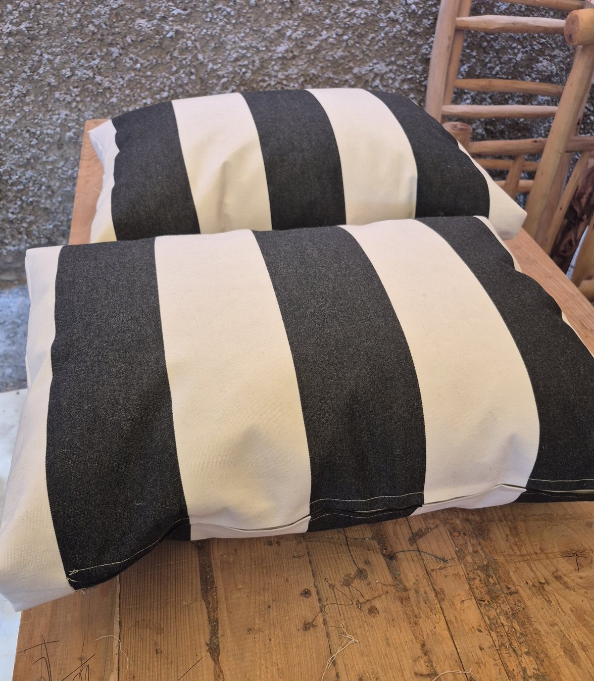 Pair of black and white striped outdoor cushions