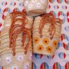 Moroccan straw basket bags embroidered with white daisies and yellow sunflowers