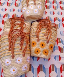 Moroccan straw basket bags embroidered with white daisies and yellow sunflowers
