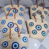 Moroccan palm-leaf basket bags embroidered with blue and turquoise evil eyes