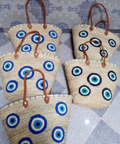 Moroccan palm-leaf basket bags embroidered with blue and turquoise evil eyes