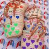 Moroccan straw basket bags embroidered with colourful fluffy hearts
