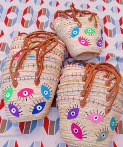Moroccan straw basket bags embroidered with colourful eyes with lashes