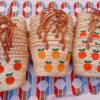 Moroccan straw basket bags embroidered with orange fruit and green leaves
