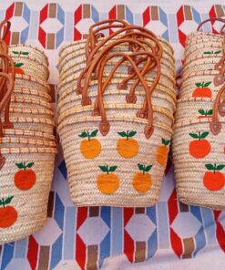 Moroccan straw basket bags embroidered with orange fruit and green leaves