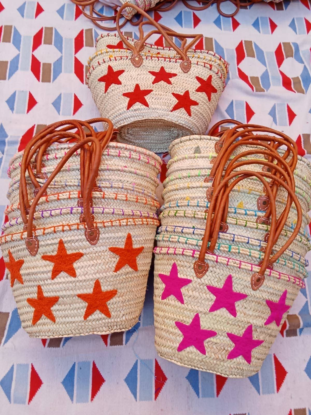 Moroccan straw basket bags embroidered with red, orange and pink stars