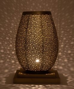 Moroccan brass pebble table lamp glowing and scattering dotted light across the walls